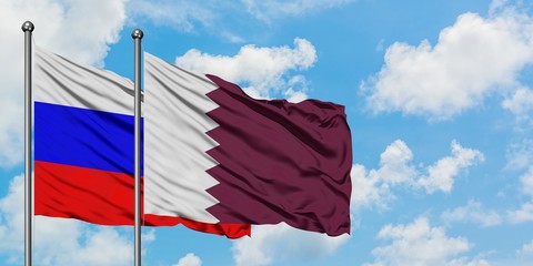 Russia and Qatar flag waving in the wind against white cloudy blue sky together. Diplomacy concept,...