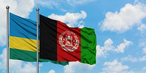 Rwanda and Afghanistan flag waving in the wind against white cloudy blue sky together. Diplomacy concept, international relations.