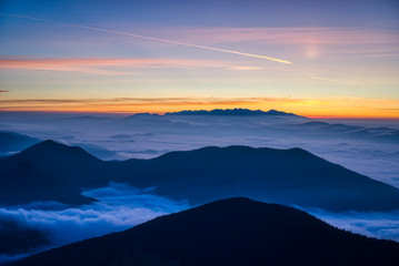 Mist flood the valley and mountains at the beautiful sunrise, slovakia, great rozutec