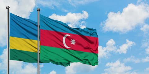 Rwanda and Azerbaijan flag waving in the wind against white cloudy blue sky together. Diplomacy concept, international relations.