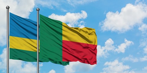 Rwanda and Benin flag waving in the wind against white cloudy blue sky together. Diplomacy concept, international relations.