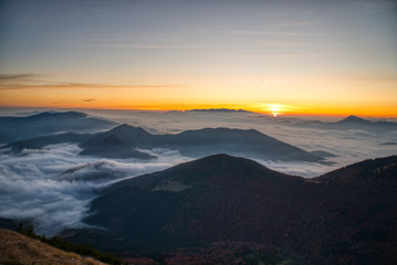 Fototapeta na wymiar Mist flood the valley and mountains at the beautiful sunrise, slovakia, great rozutec