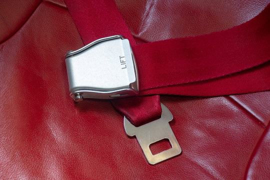 Available Red Seat Belt On Air Plane As For Transportation Safety.