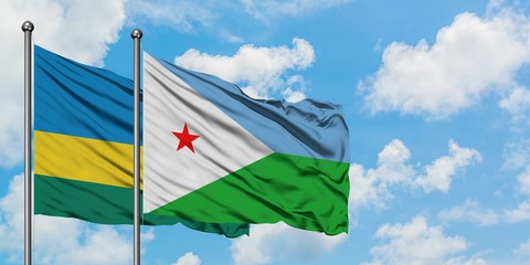 Rwanda and Djibouti flag waving in the wind against white cloudy blue sky together. Diplomacy concept, international relations.