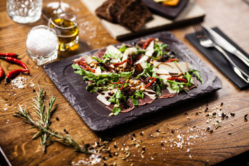 Beef carpaccio served on a board in restaurant