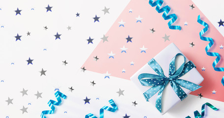 Fototapeta premium Gift box with confetti and ribbons - overhead view flat lay
