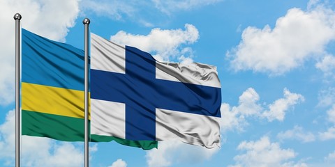 Rwanda and Finland flag waving in the wind against white cloudy blue sky together. Diplomacy concept, international relations.