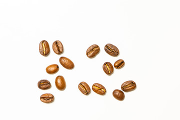 Separate coffee beans on the white background. Background photo or texture. Pattern.