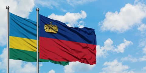 Rwanda and Liechtenstein flag waving in the wind against white cloudy blue sky together. Diplomacy concept, international relations.