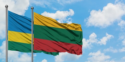 Rwanda and Lithuania flag waving in the wind against white cloudy blue sky together. Diplomacy concept, international relations.