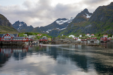 A fishing village in Lofoten islands called A/&Atilde;&hellip;. Red little houses and the beautiful mountain in the bckground with soft light. Travel and explore concept.