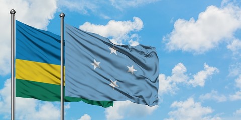 Rwanda and Micronesia flag waving in the wind against white cloudy blue sky together. Diplomacy concept, international relations.