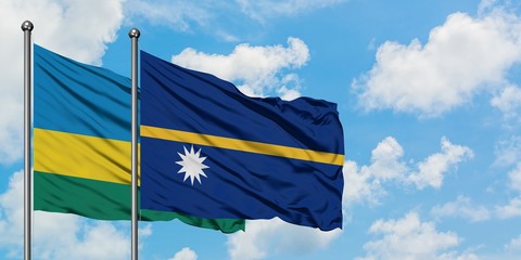 Rwanda and Nauru flag waving in the wind against white cloudy blue sky together. Diplomacy concept, international relations.