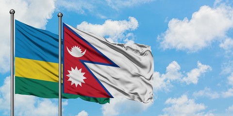 Rwanda and Nepal flag waving in the wind against white cloudy blue sky together. Diplomacy concept,...