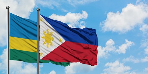 Rwanda and Philippines flag waving in the wind against white cloudy blue sky together. Diplomacy concept, international relations.