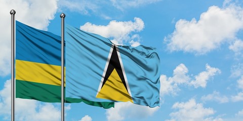 Rwanda and Saint Lucia flag waving in the wind against white cloudy blue sky together. Diplomacy concept, international relations.