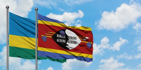 Rwanda and Swaziland flag waving in the wind against white cloudy blue sky together. Diplomacy concept, international relations.
