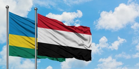 Rwanda and Yemen flag waving in the wind against white cloudy blue sky together. Diplomacy concept, international relations.