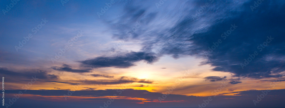 Wall mural panorama sunlight with dramatic sky. cumulus sunset clouds with sun setting down on dark background.