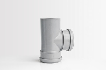 Plastic PVC pipes sewer fittings on a light background.