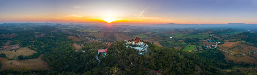 Fototapeta na wymiar Top view Aerial photo from flying drone.The beautiful of Thai temple (Wat Pa Phu Hai Long) on the top of mountain in Pak Chong District,Nakorn Ratchasima, Thailand.