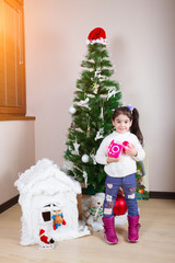 Happy little girl received a toy for Christmas