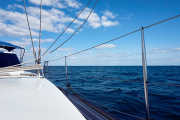 The yacht is moving along the coast. Beautiful view from a bow of yacht at seaward. Boat bow...