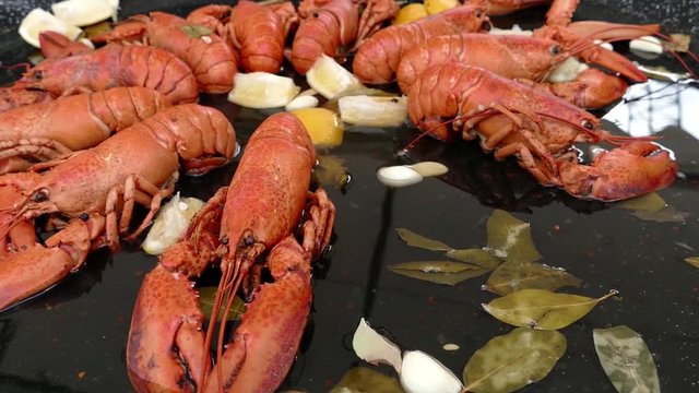 Background with fresh crayfish, crabs and octopus in a big pan