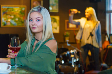 Girl with alcohol glass in pub club