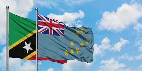 Saint Kitts And Nevis and Tuvalu flag waving in the wind against white cloudy blue sky together. Diplomacy concept, international relations.