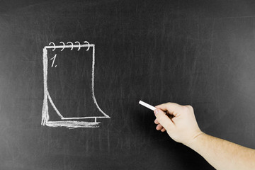 Drawn notepad on blackboard and chalk