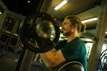 gym lifestyle portrait of young athletic and attractive man smiling happy and natural training...