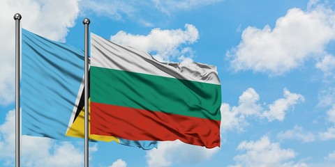 Saint Lucia and Bulgaria flag waving in the wind against white cloudy blue sky together. Diplomacy concept, international relations.