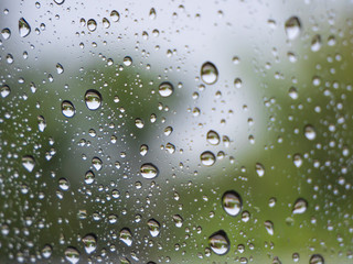 Water rain drops on window glass in rainy season.