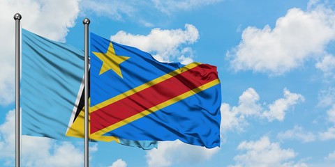 Saint Lucia and Congo flag waving in the wind against white cloudy blue sky together. Diplomacy concept, international relations.
