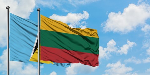 Saint Lucia and Lithuania flag waving in the wind against white cloudy blue sky together. Diplomacy concept, international relations.