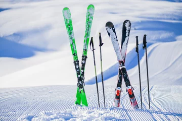 Fotobehang Skis in snow in winter season, mountains and ski items or equipments on the top in dolomites, © Milan