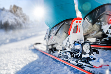 Winter skis and detailed view of the ski bindings concept in sunny day. - obrazy, fototapety, plakaty