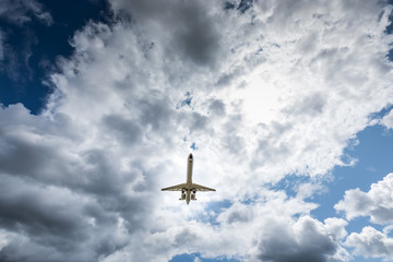 Jet airplane flying in the cloudy skies