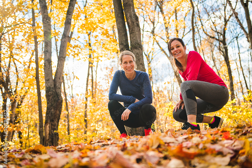 Wall mural two running woman jogging in autumn nature