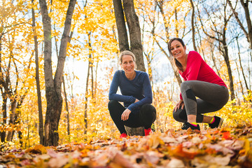 Two running woman jogging in autumn nature