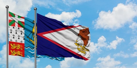 Saint Pierre And Miquelon and American Samoa flag waving in the wind against white cloudy blue sky...