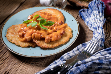 Homemade potato pancakes with goulash.