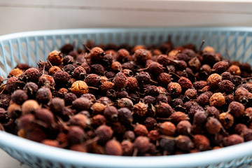 dried hawthorn berry in a blue basket