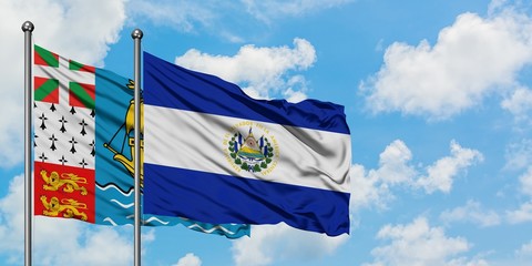 Saint Pierre And Miquelon and El Salvador flag waving in the wind against white cloudy blue sky together. Diplomacy concept, international relations.
