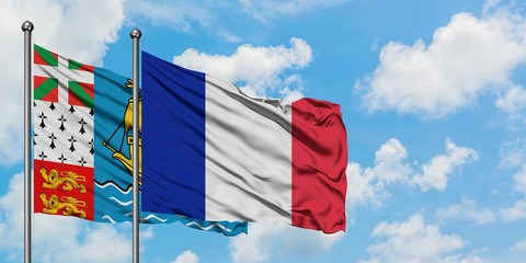 Saint Pierre And Miquelon and France flag waving in the wind against white cloudy blue sky together. Diplomacy concept, international relations.