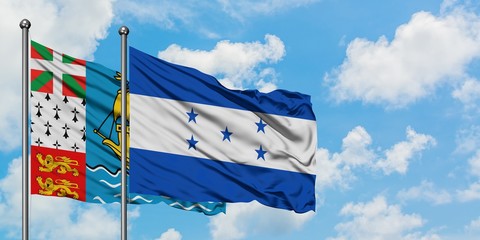 Saint Pierre And Miquelon and Honduras flag waving in the wind against white cloudy blue sky together. Diplomacy concept, international relations.