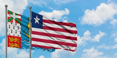 Saint Pierre And Miquelon and Liberia flag waving in the wind against white cloudy blue sky together. Diplomacy concept, international relations.