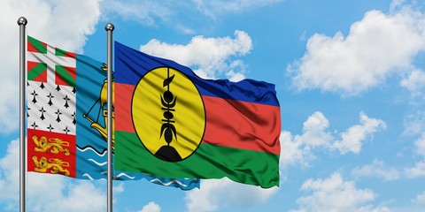 Saint Pierre And Miquelon and New Caledonia flag waving in the wind against white cloudy blue sky together. Diplomacy concept, international relations.