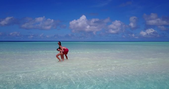Couple of travelers walking ocean lagoon in Bali,  man and woman together on vacation
